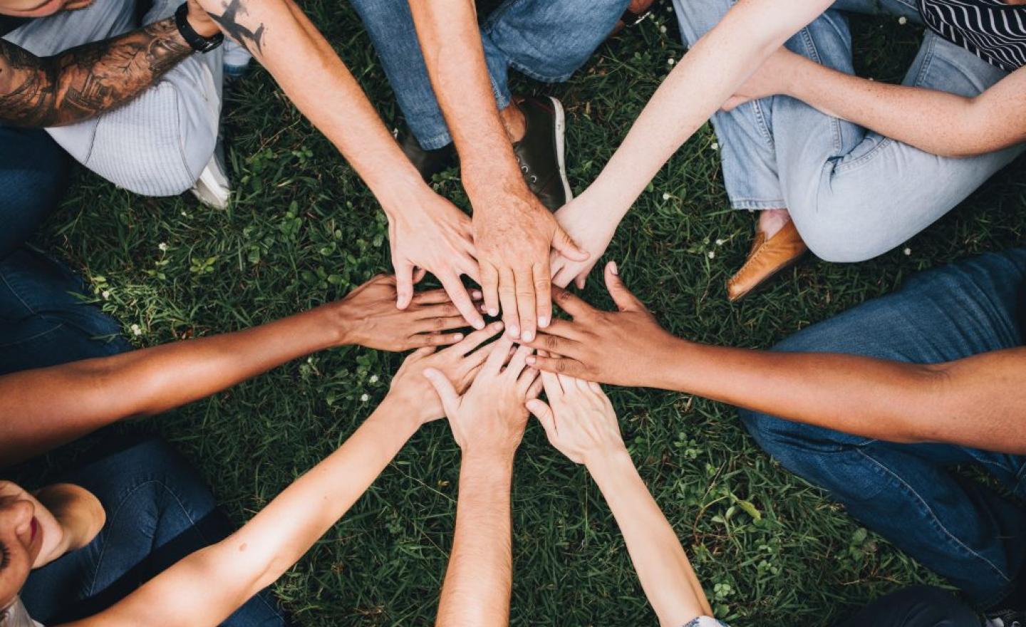 Group of people with hands together