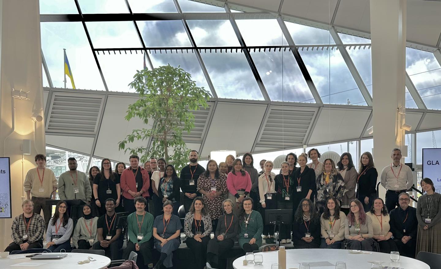 A group of people from the GLA Democratic Participation Grants programme on stage at an event at City Hall