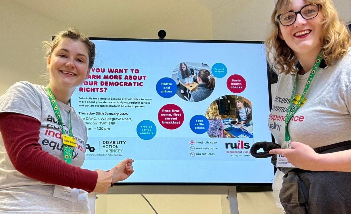 Ruils staff standing in front of a presentation screen about civic and democratic rights