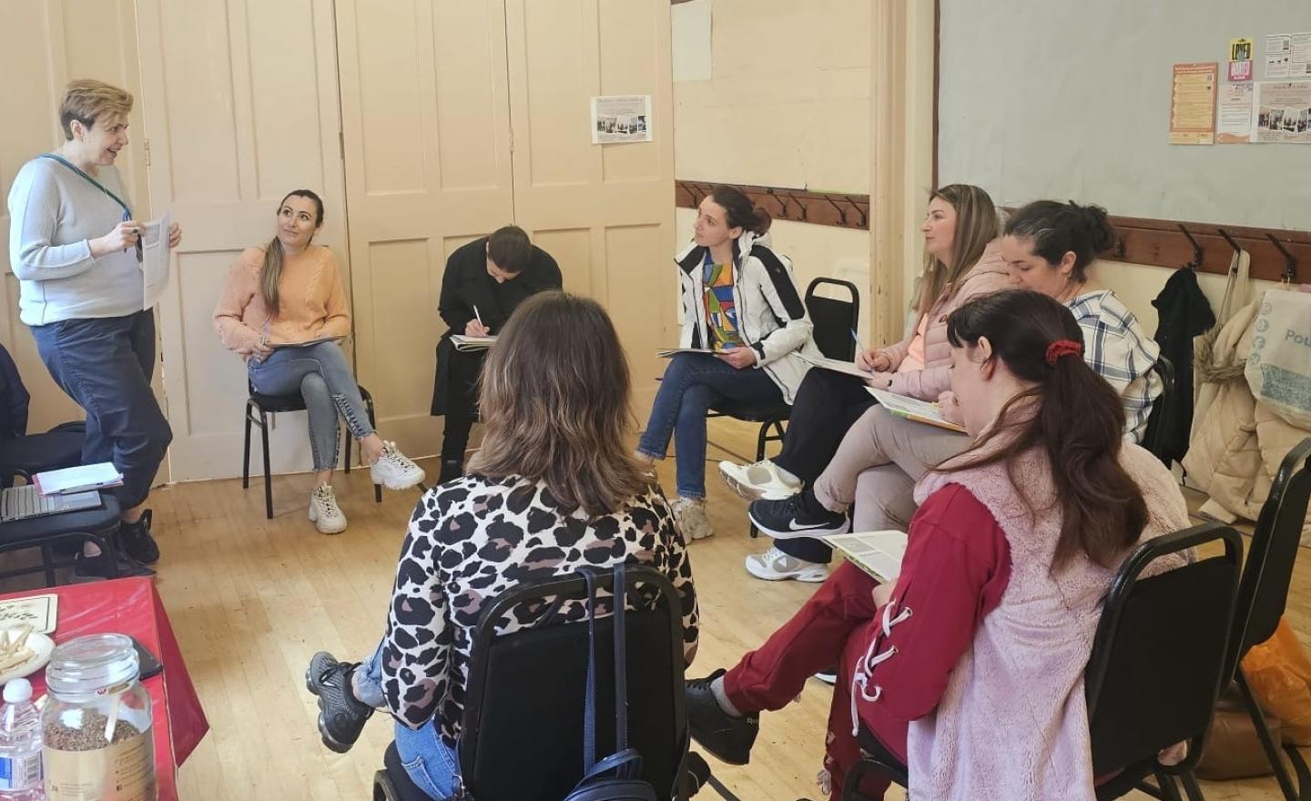 A group of women sitting in a circle learning about civic and democratic participation with RCCT