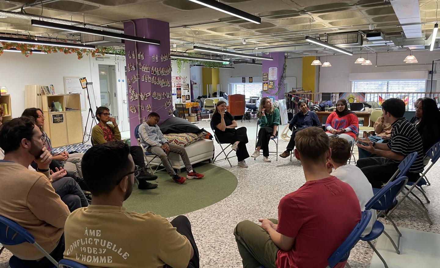 A group of professionals sitting in a circle engaging with a training session on how to use the ATT toolkit