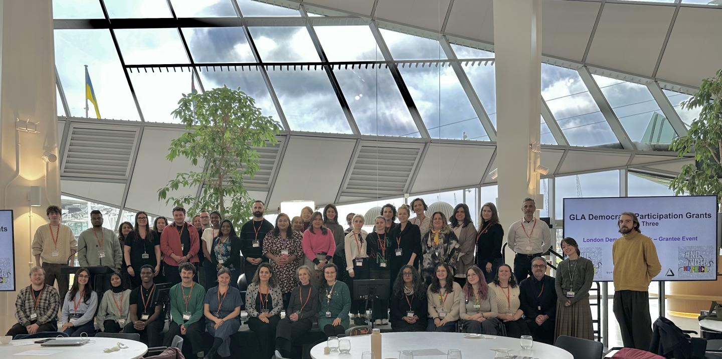 A group of people from the GLA Democratic Participation Grants programme on stage at an event at City Hall