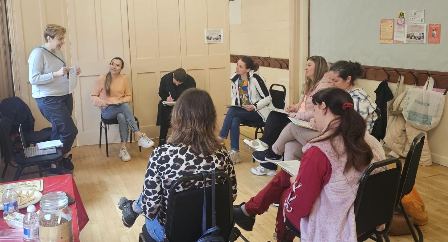 A group of women sitting in a circle learning about civic and democratic participation with RCCT