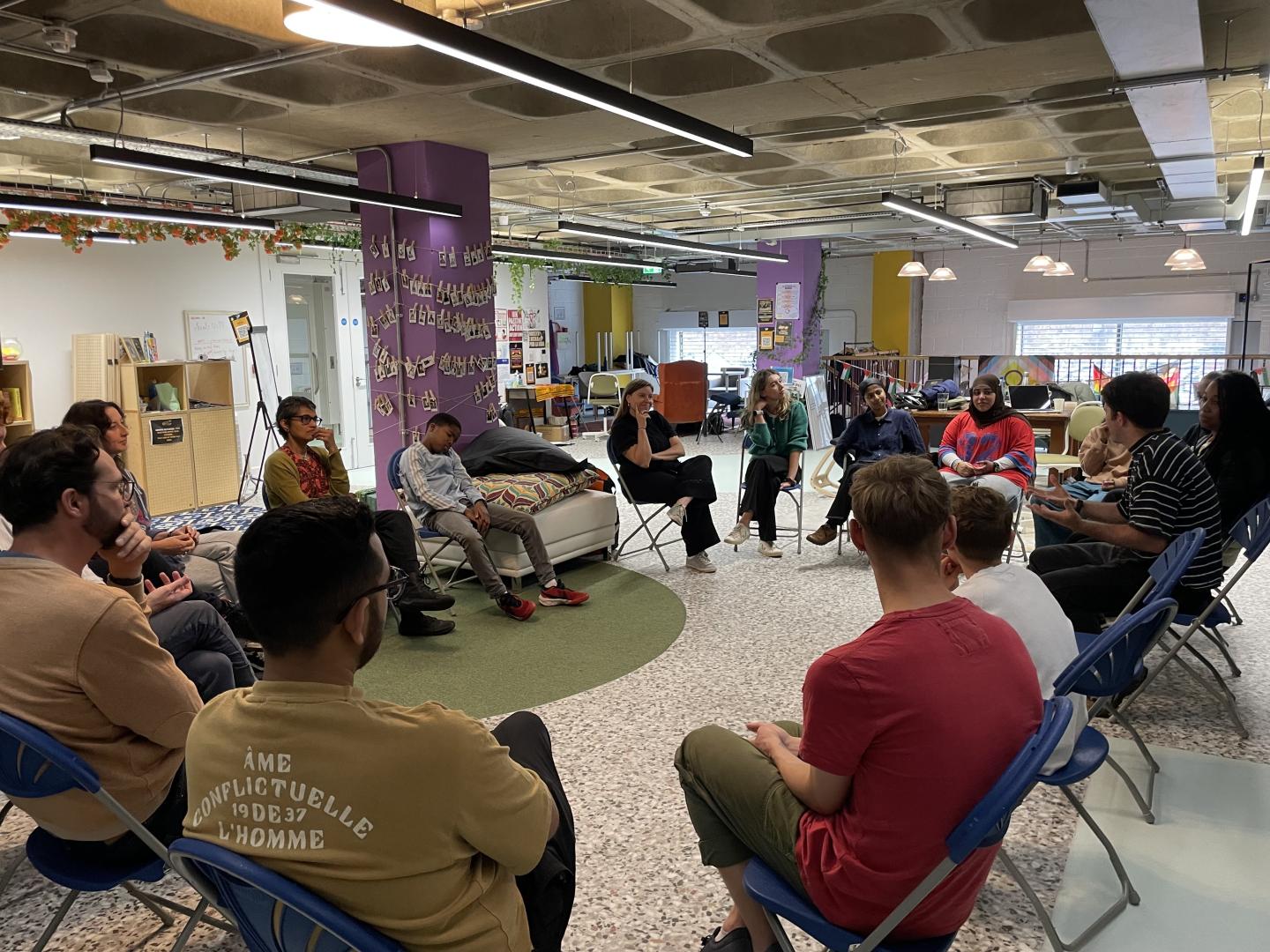 A group of professionals sitting in a circle engaging with a training session on how to use the ATT toolkit